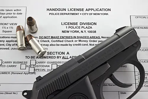 Image of handgun and application permit form