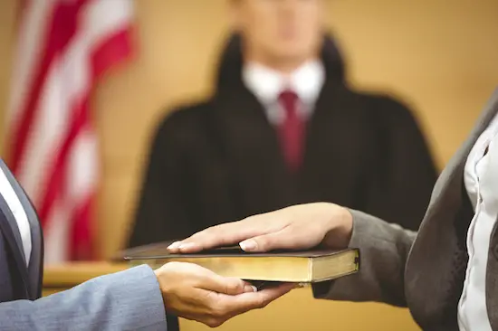 Pledging oath in court on a bible