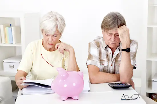 Portrait Of Upset Senior Couple Calculating Finance At Home