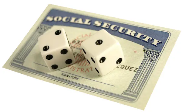 Image of Social Security card with 2 dice on top of it