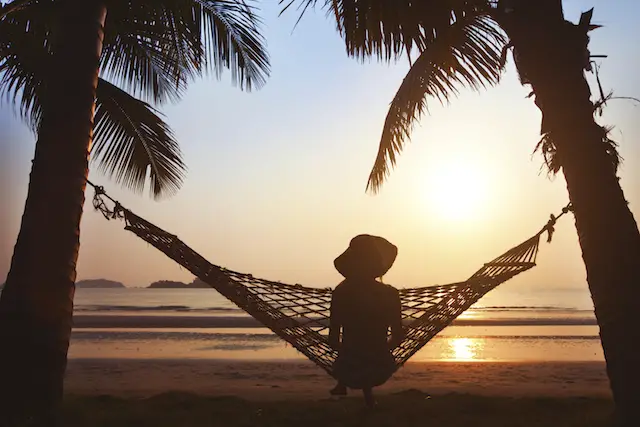 Image of woman in hammock watching the sunset