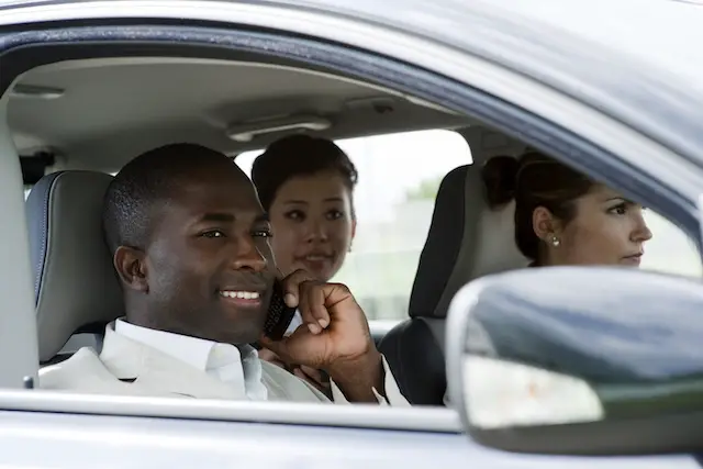 Image of businesspeople sharing a ride in a car