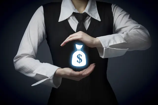 Image of a businesswoman with a money bag symbol between her hands