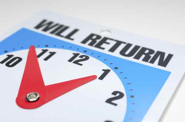 Image of a will return clock sign close up