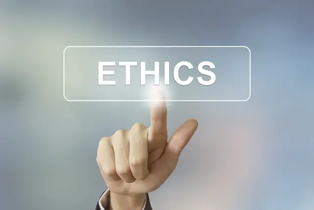 business hand pushing ethics button on blurred background