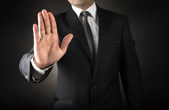 Businessman showing stop sign gesture with his hand
