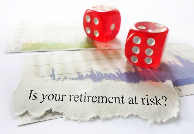 News headline reading 'Is your retirement at risk?' with dice and stock market charts