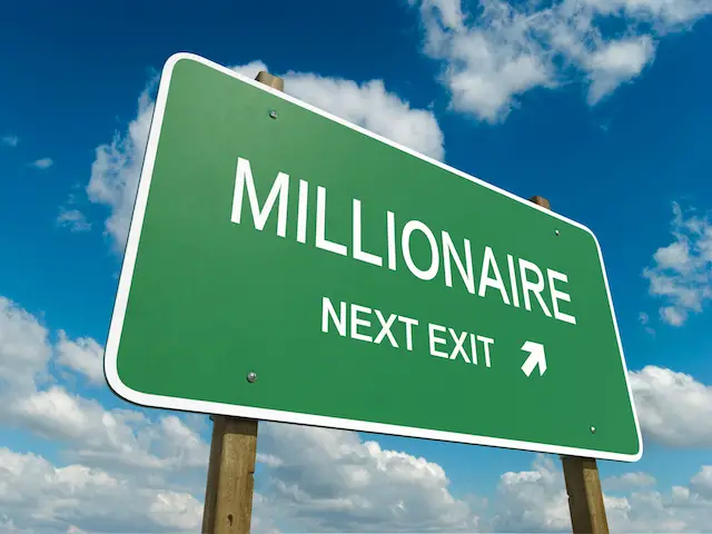 Road exit sign saying 'millionaire next exit'