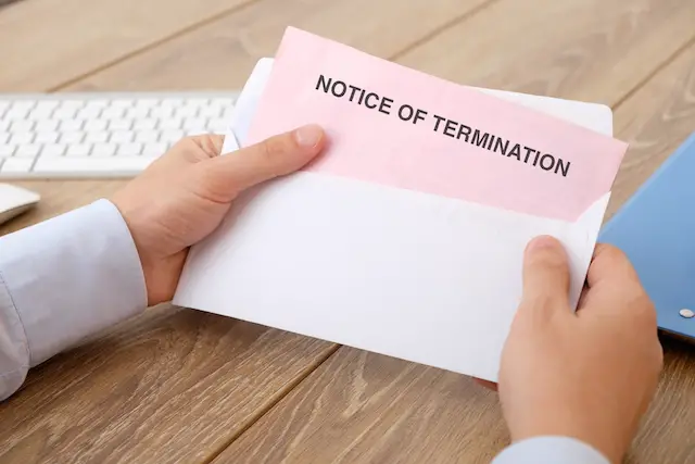 Fired business man reads the notice of job termination