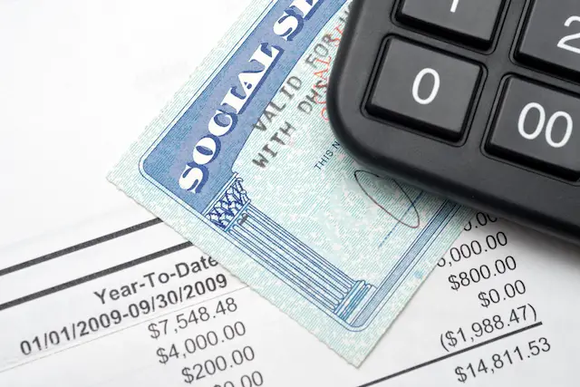 Social Security card with a financial statement and a calculator