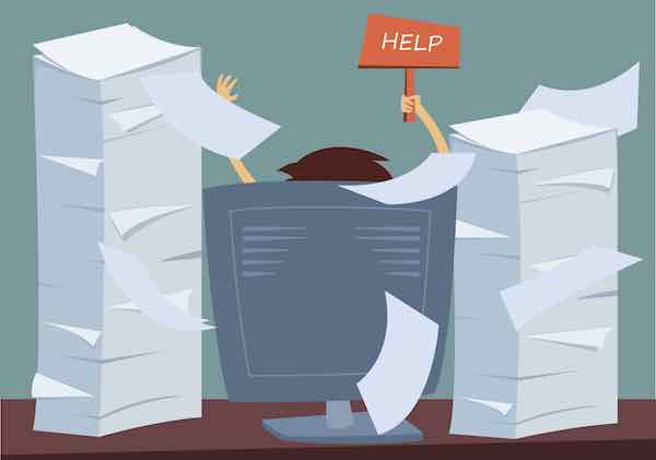 Cartoon depiction of a person sitting at a desk hidden behind stacks of paperwork holding up a 'help' sign
