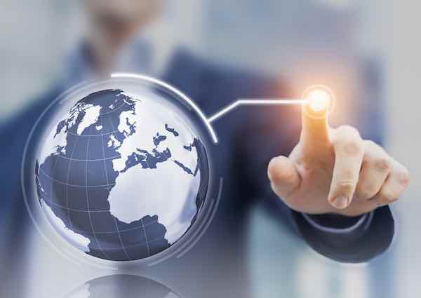 Worldwide business concept with 3D globe interface and businessman touching a button
