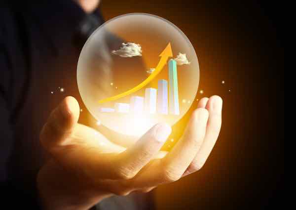Business hand holding rising financial chart in crystal ball