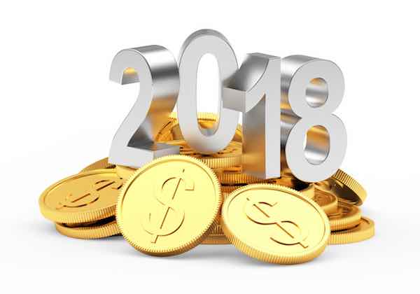 Silver numbers 2018 on a pile of golden coins isolated on a white background