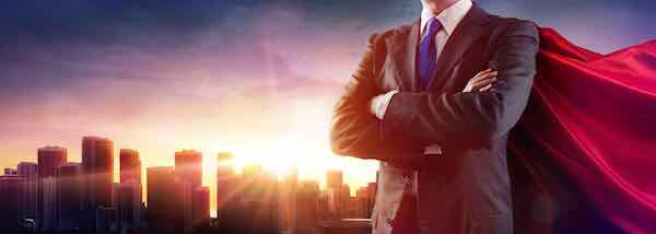Businessman superhero with red cape standing with his arms crossed in front of a city skyline