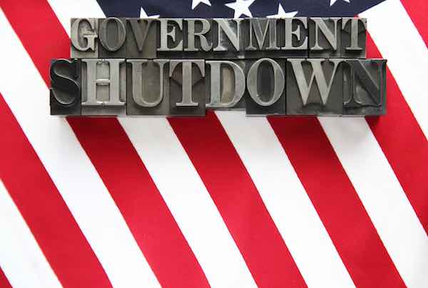 Words 'government shutdown' overlaid on an american flag