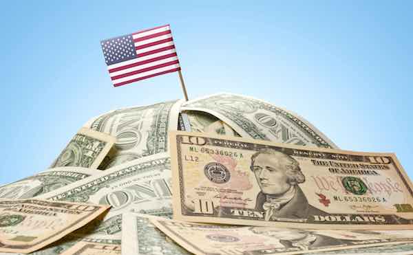 US flag sticking in a pile of American dollars