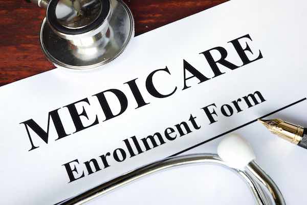 Words 'Medicare enrollment form' written on a paper