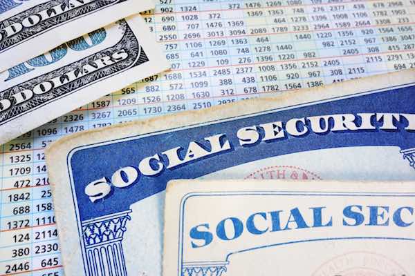 Social Security cards with cash and benefit amount numbers