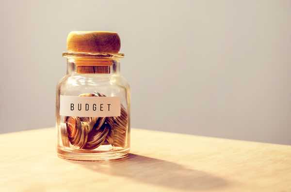 Coins in a jar labeled 'budget'