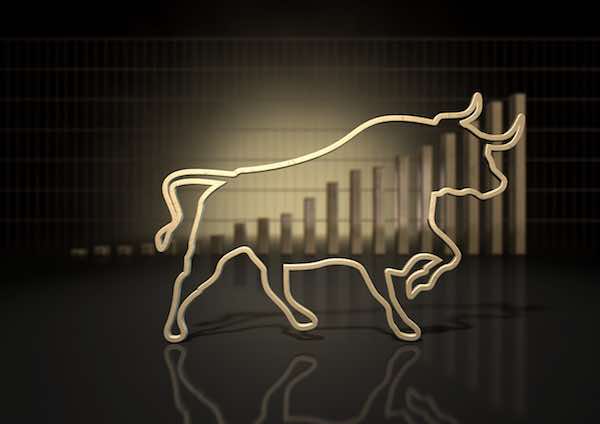 An abstract closeup of a gold outline depicting a stylized bull representing financial market trends on a bar graph background