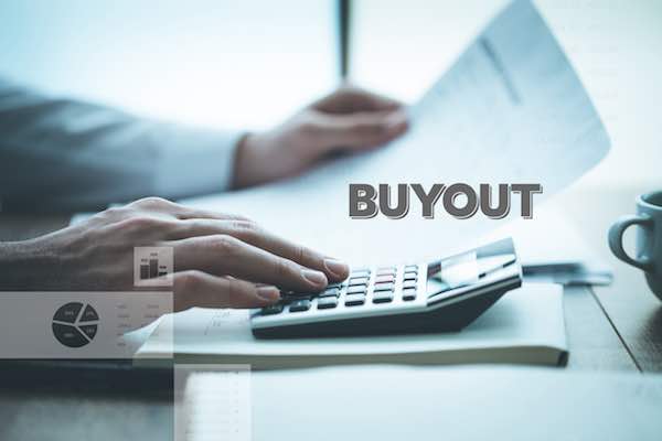 businessman sitting at a desk looking at paperwork and performing calculations on a calculator with the word 'buyout' superimposed over the scene