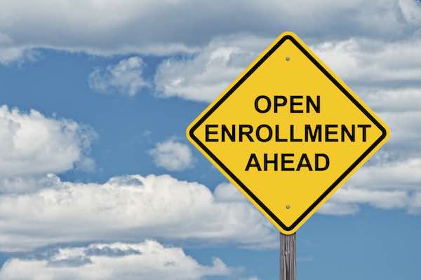 Yellow caution sign that reads 'open enrollment ahead'