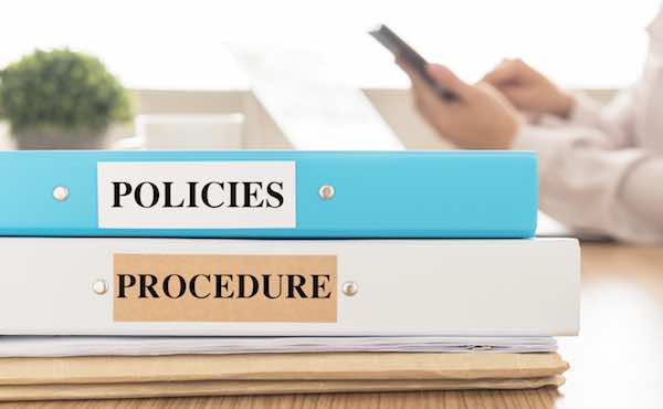 Policies and Procedures handbooks sitting on a desk