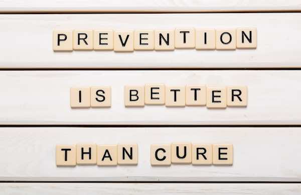 Words 'prevention is better than cure' written in Scabble letters on a white background