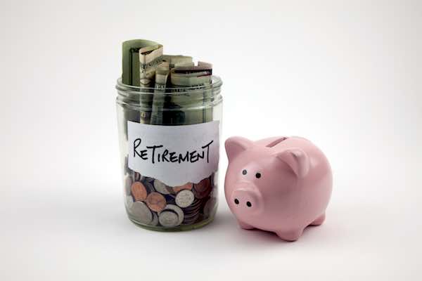 Pink piggy bank next to a jar of money labeled 'retirement'