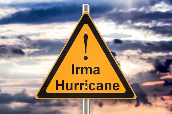 Triangular yellow road warning sign reading 'Irma Hurricane'