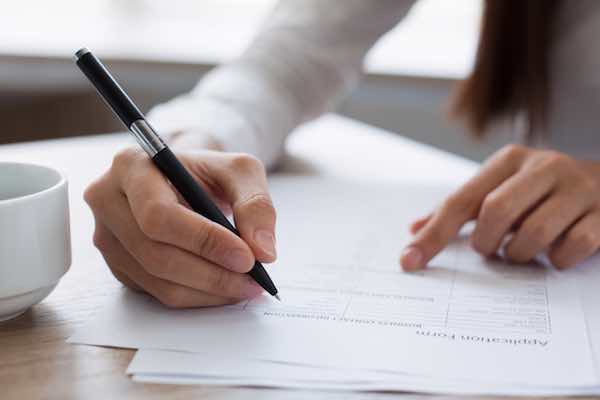 Closeup of a woman completing a job application form