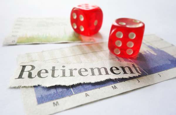 Retirement newspaper headline with dice and stock market graphs