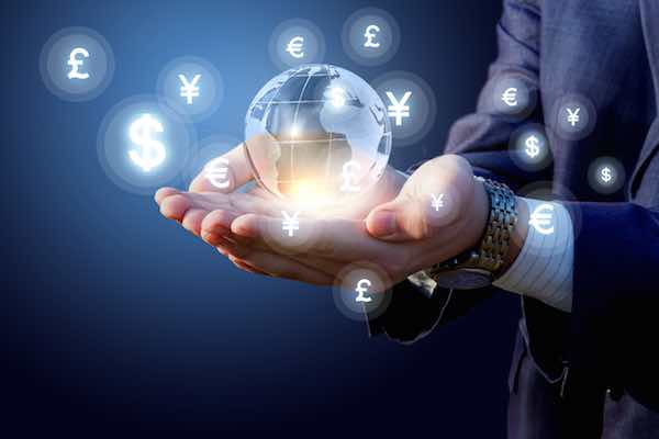 Close up of a businessman's hands holding a glass globe depicting world financial markets