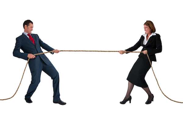 businessman and woman engaged in tug of war rivalry