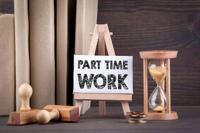 Flip chart sign labeled 'part-time work' next to an hourglass