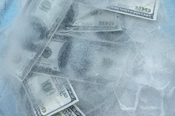 $100 bills frozen inside a block of ice - pay freeze