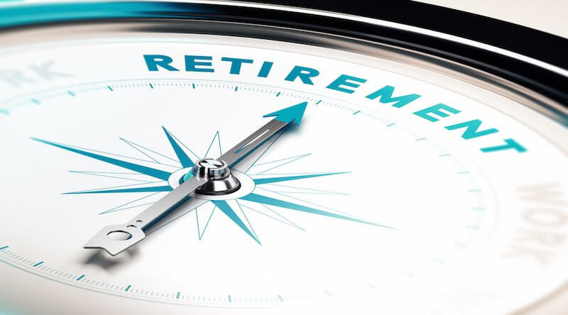 Compass with the arrow pointing towards the word 'retirement'