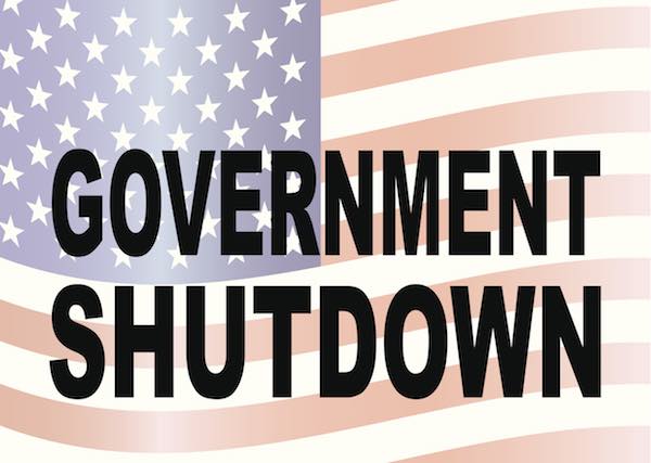Words 'government shutdown' overlaid on top of an image of the American flag