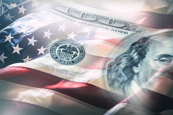 US flag waving with an image of a $100 bill blended into it