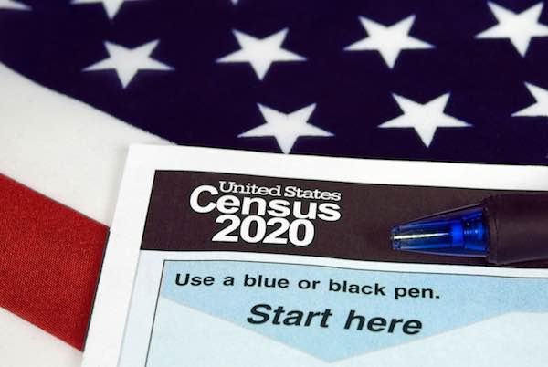 2020 US Census form with ball point ink pen on an American flag