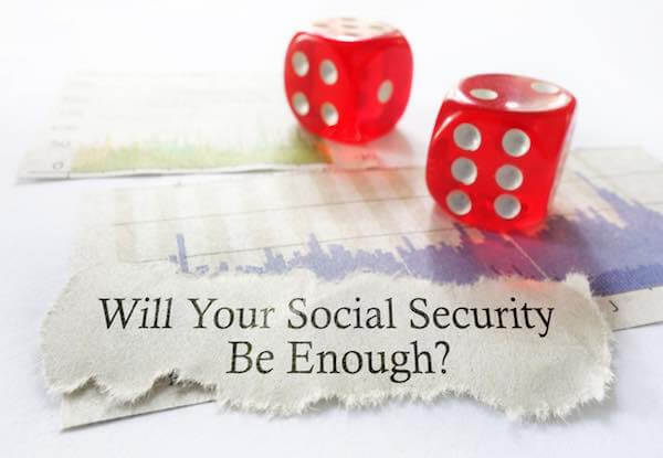 Two red dice sitting on a tear out of a headline that reads 'Will Your Social Security Be Enough?'
