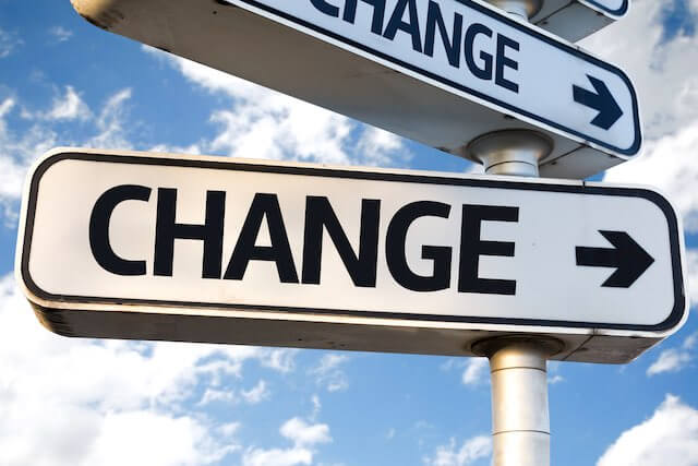 Close up of a road name sign with the word 'change' on it with an arrow pointing towards the right