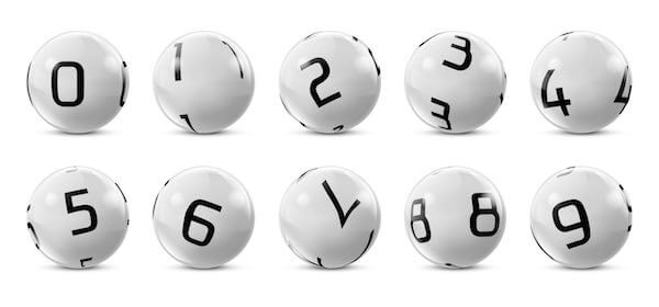 Series of bingo ping-pong balls each with a different number on them lined up against a solid white background
