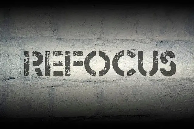 Word 'refocus' written on a black background