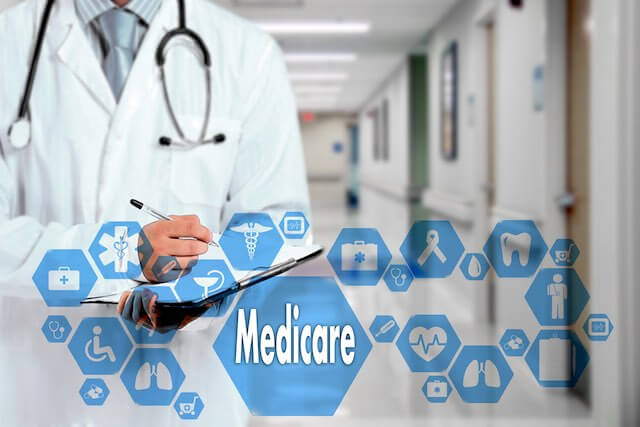 Image of a doctor in a white coat holding a clipboard with the word 'medicare' pictured in the foreground next to various blue icons depicting health, wellness, FEHB, and open enrollment services