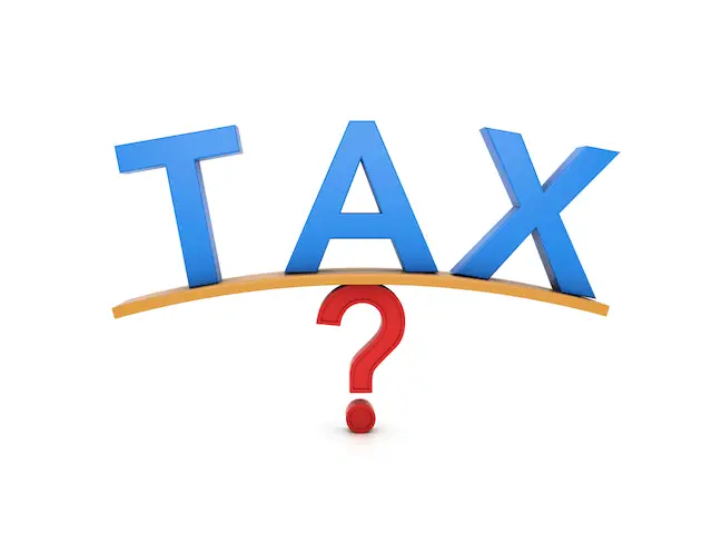 Word 'tax' balanced over a question mark depicting debate over tax increases