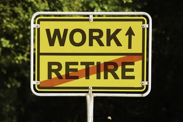 Yellow sign with an arrow that you are on the way to work and leaving retirement - retire or keep working concept
