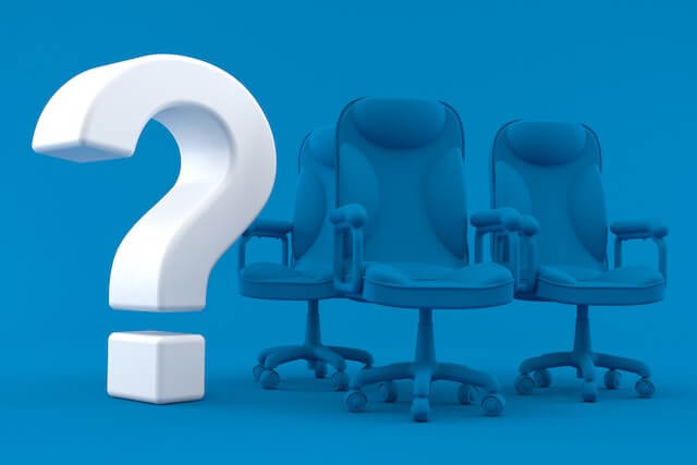 3D white question mark next to three executive office chairs against a blue background