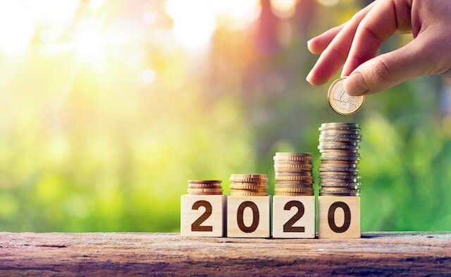 Block numbers that read '2020' with growing stacks of coins on top of them indicating a pay raise in 2020